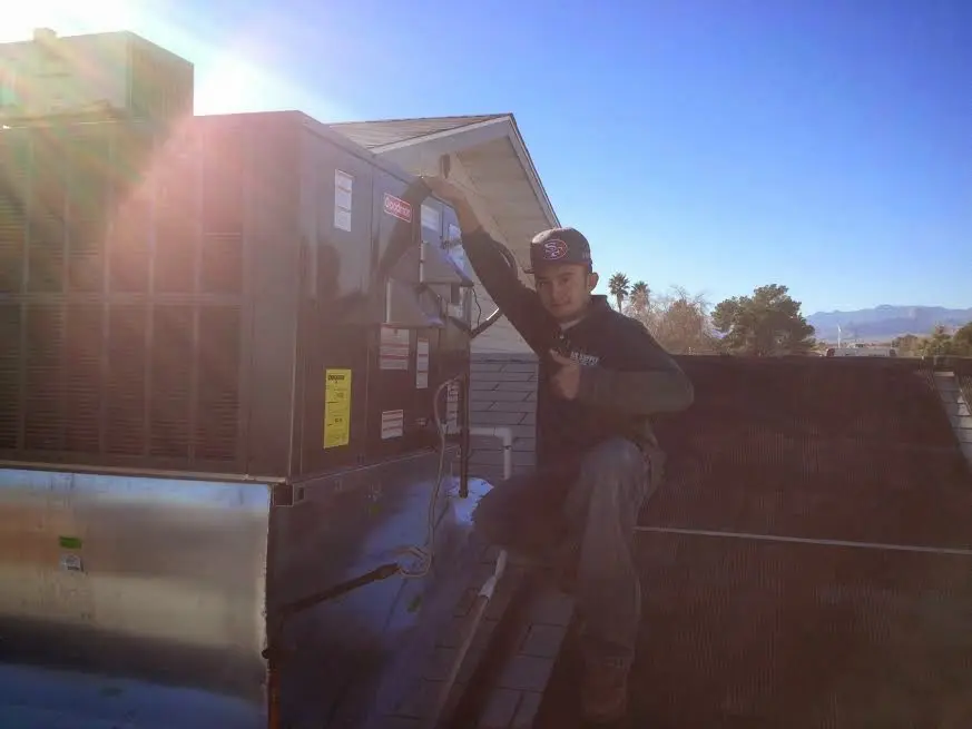 HVAC technician performing HVAC Inspection on a rooftop unit in Champion Heights
